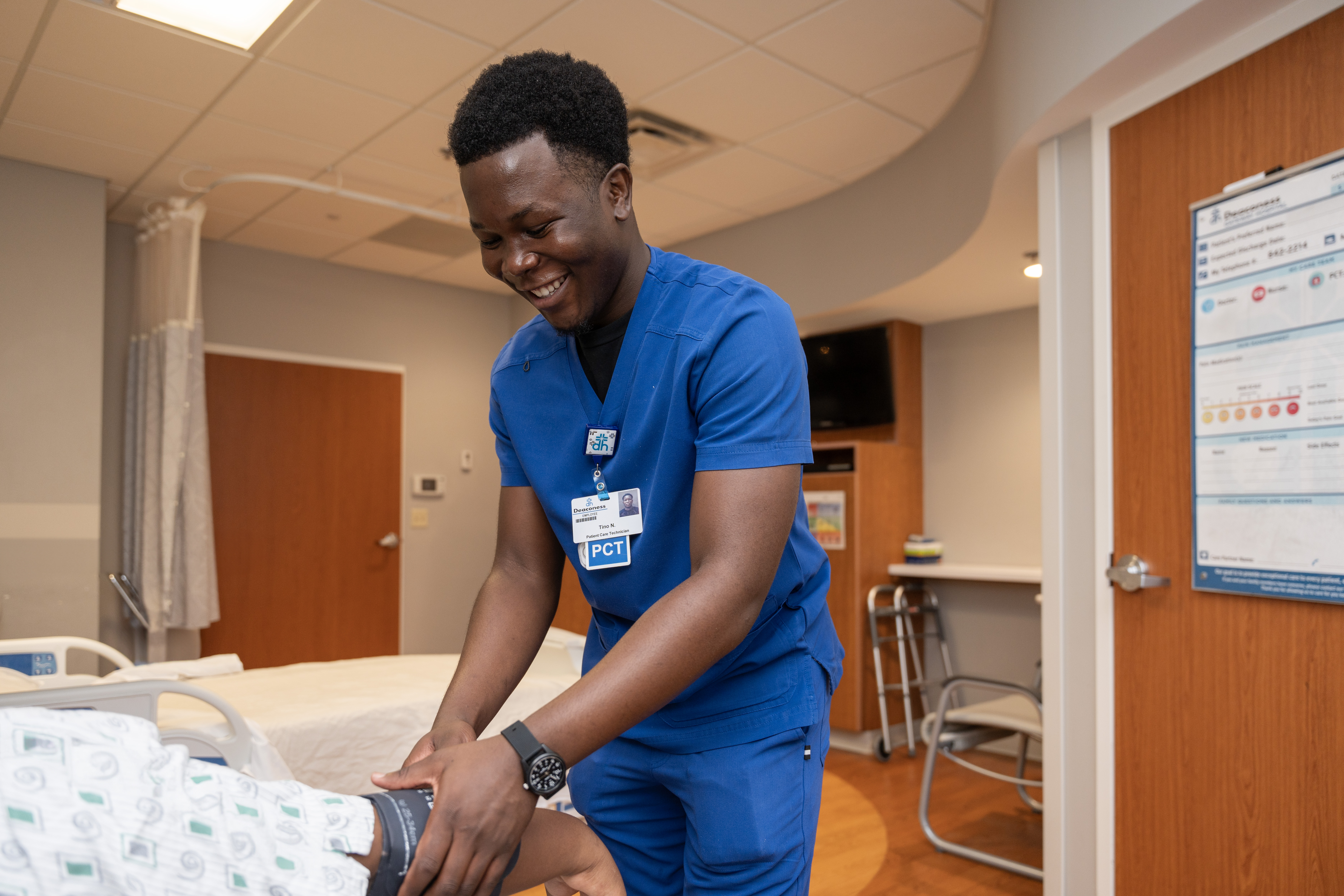 male nursing student taking patient blood pressure
