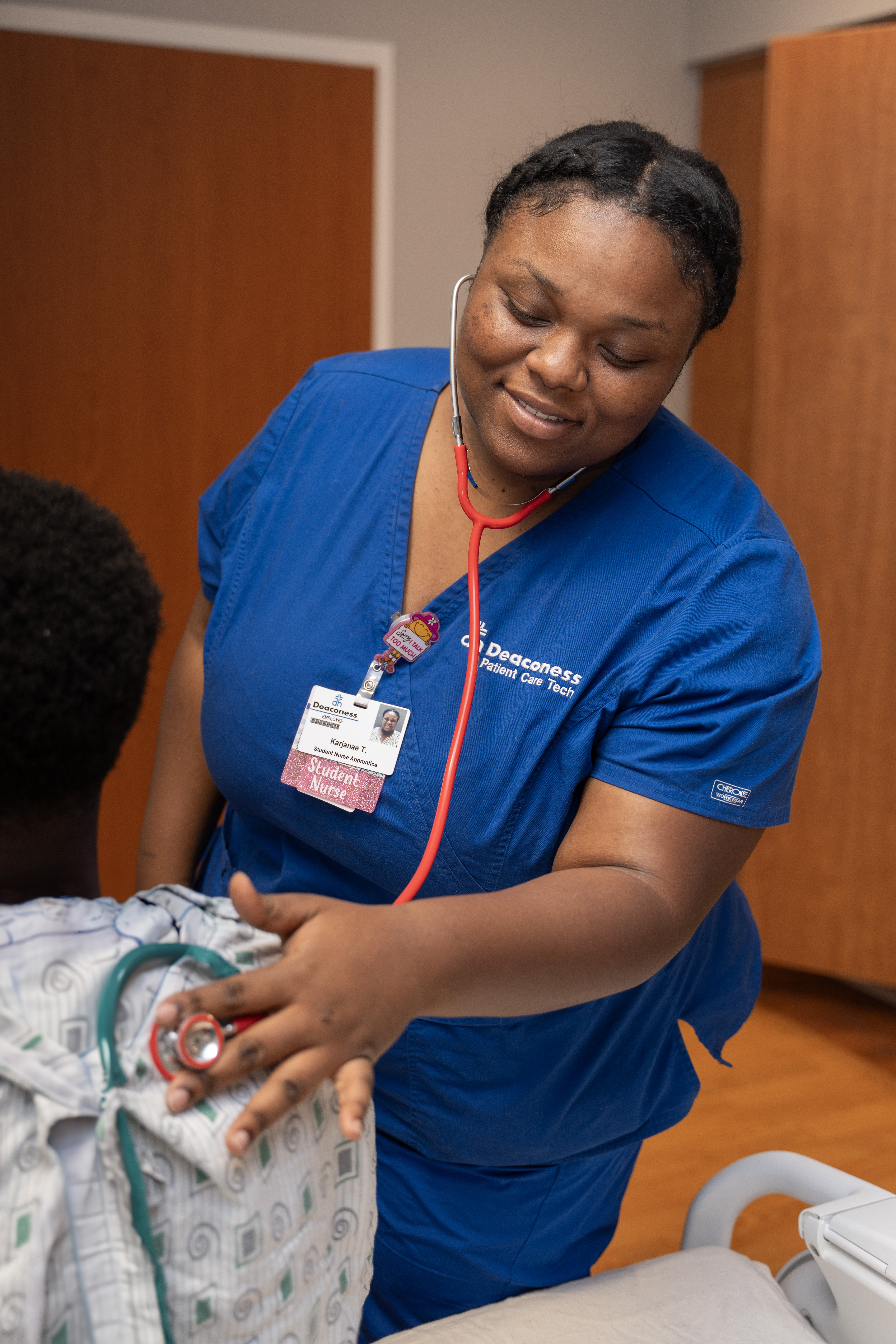 female nursing student checking patient heartbeat