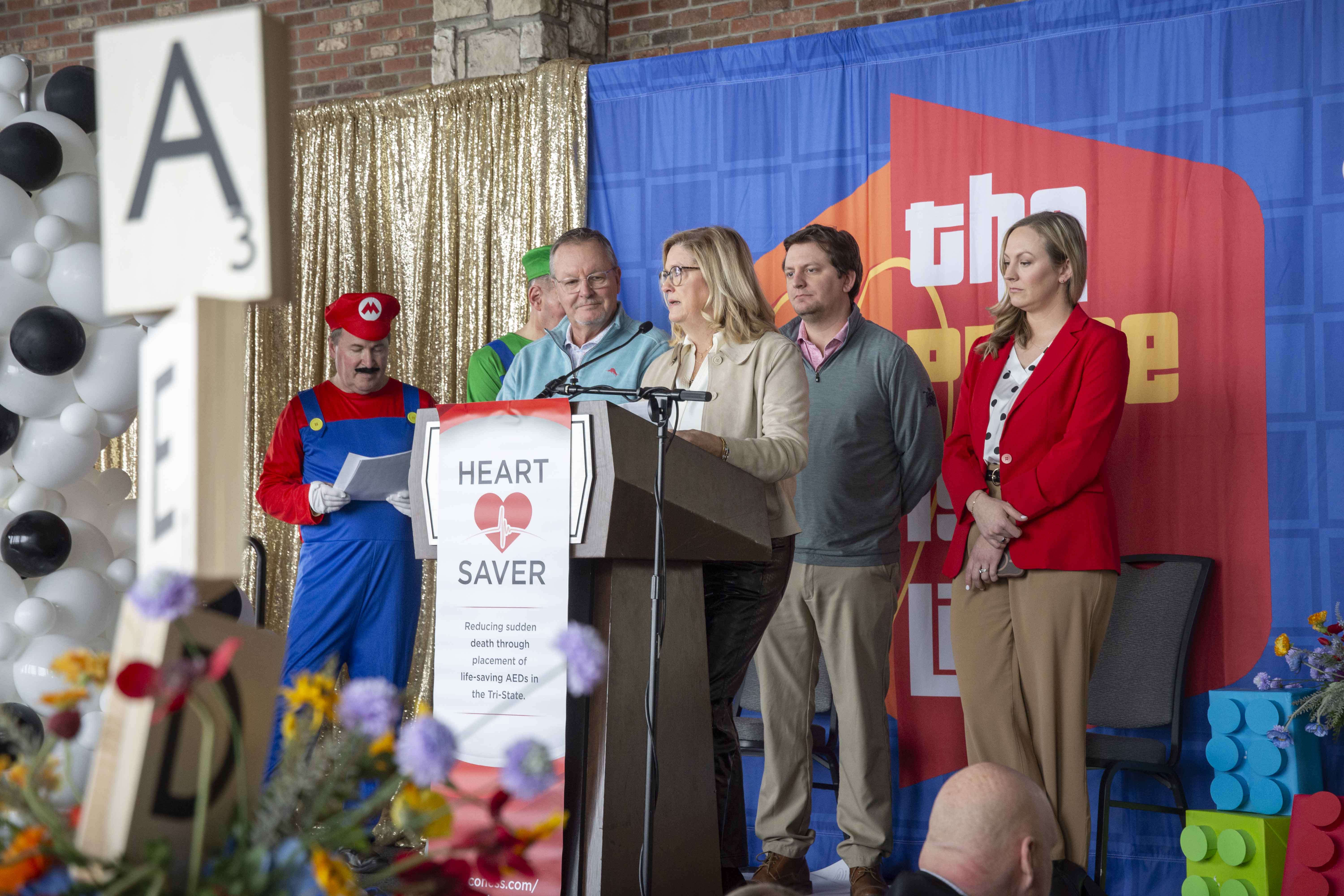 Individuals stand at the podium during the 2026 HeartSaver "Game on for Hearts" Luncheon