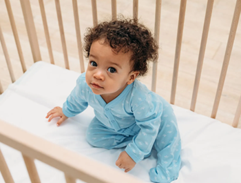 baby looking up from a crib