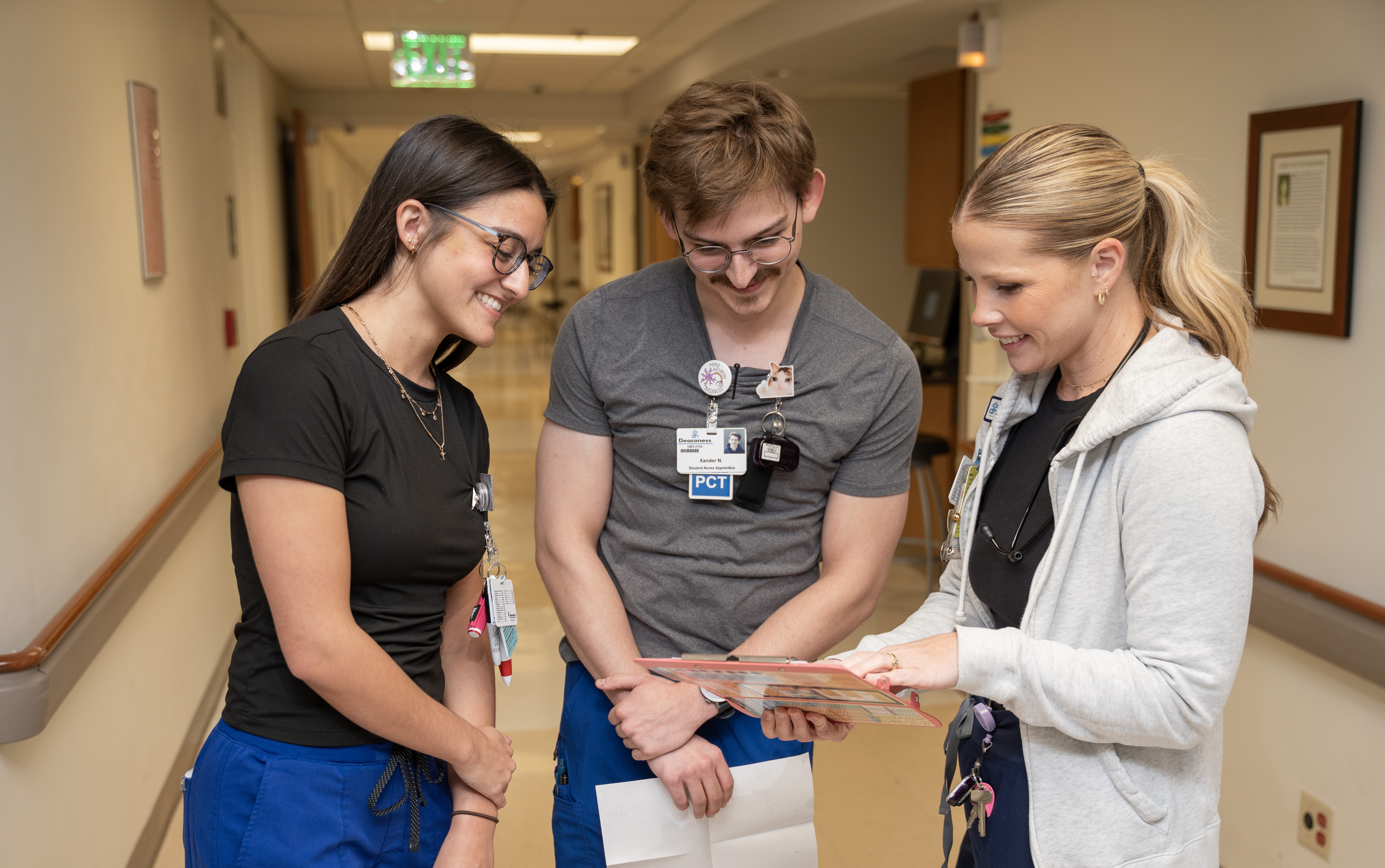 two nursing students speaking with their trainer